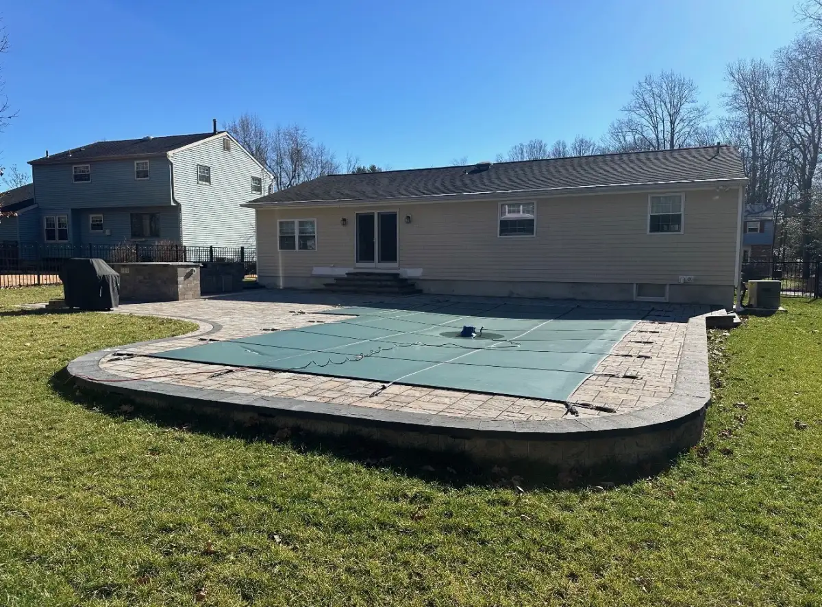 Landscape lighting illuminating trees, garden beds, and walkway at a South Jersey home