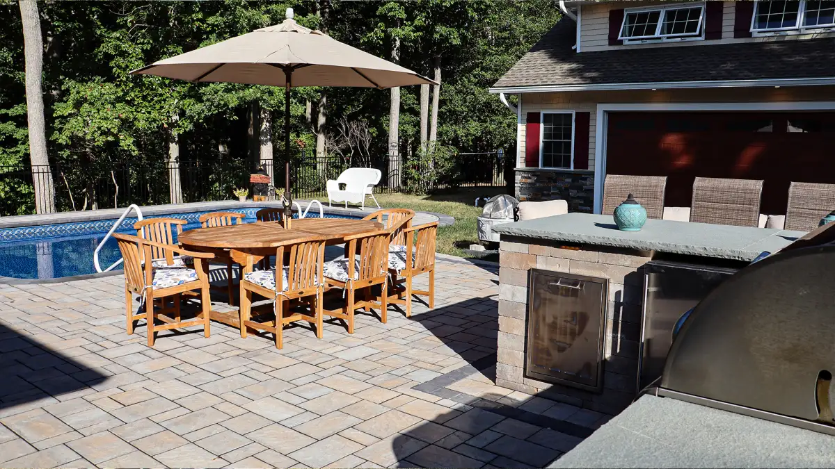 Curved seat wall integrated into paver patio with matching stone veneer