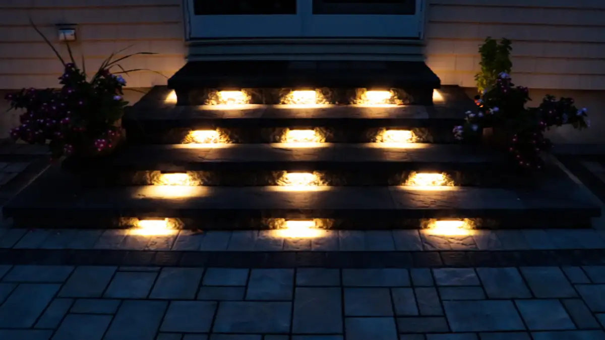 Multi-level paver patio with steps connecting to upper yard