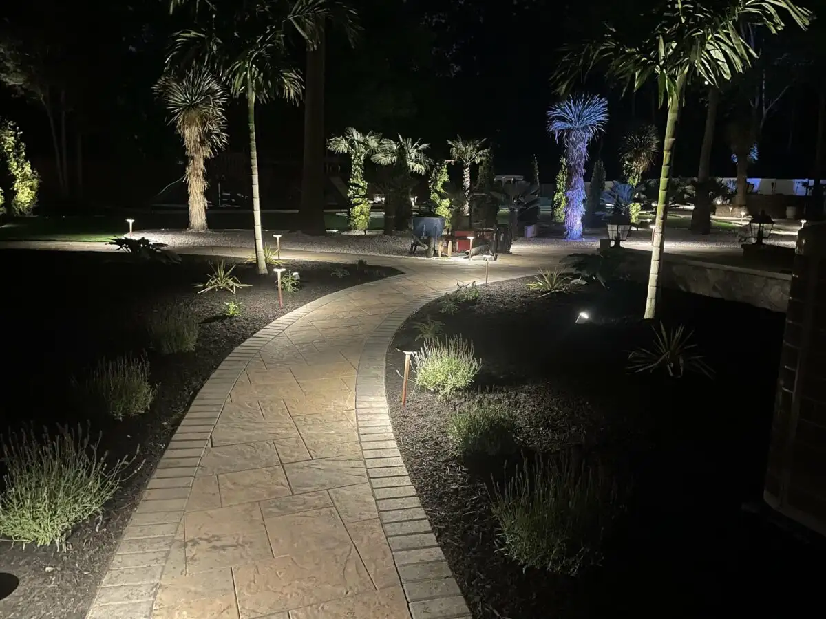 Landscape design with mixed plantings and natural stone border in South Jersey