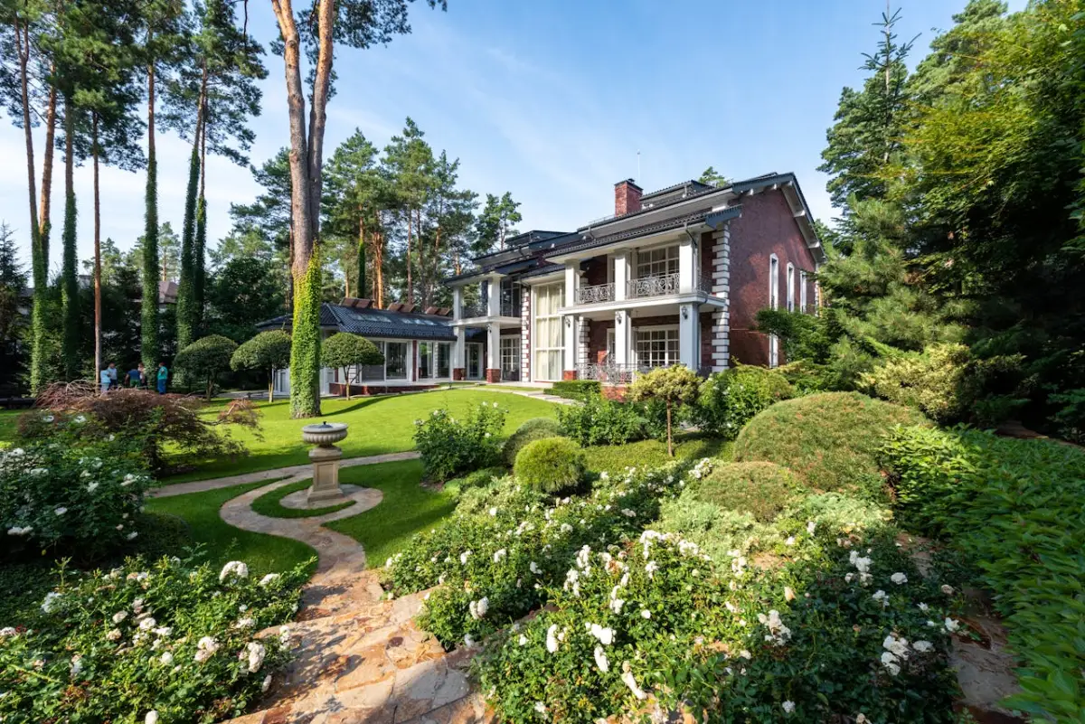 Professional landscape design with curved walkway, garden beds, and ornamental plantings